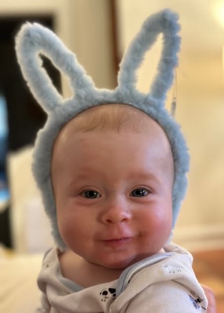 An adorable baby wearing bunny ears